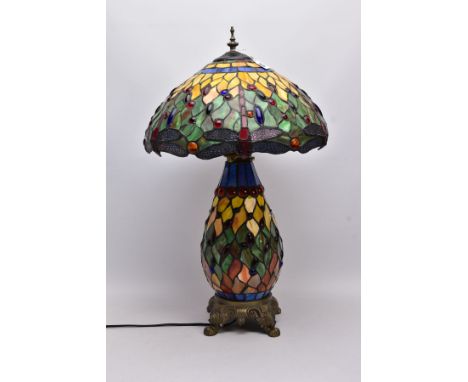 A TIFFANY STYLE TABLE LAMP, Dragonfly design to lamp shade, the baluster shaped body is mounted to a resin stand, approximate