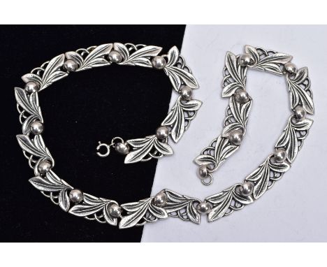 A 'BERNARD INSTONE' ARTS AND CRAFTS SILVER NECKLACE, designed with twenty openwork foliate and berry decorative links, fitted