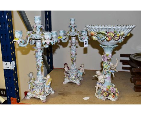 A LATE 19TH CENTURY CONTINENTAL PORCELAIN TABLE CENTREPIECE, the basket with florally encrusted exterior, the base with two c