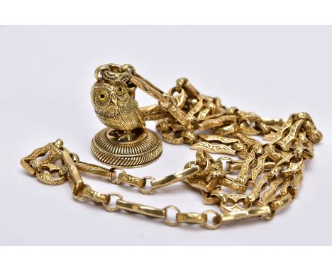 A CONTEMPORARY YELLOW METAL CHAIN WITH OWL FOB, designed with a textured fancy link chain fitted with a swivel clasp, suspend