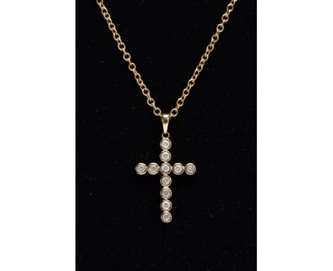A 9CT GOLD DIAMOND PENDANT NECKLET, the pendant in the form of a cross, set with eleven round brilliant cut diamonds each wit