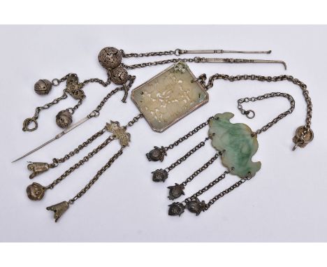 THREE WHITE METAL CHANTELAINES, the first of a belcher link chain set with a carved Oriental styled green hardstone panel, su