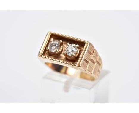 A YELLOW METAL DIAMOND SIGNET RING, of a rectangular design, with two claw set old cut diamonds, total estimated diamond weig