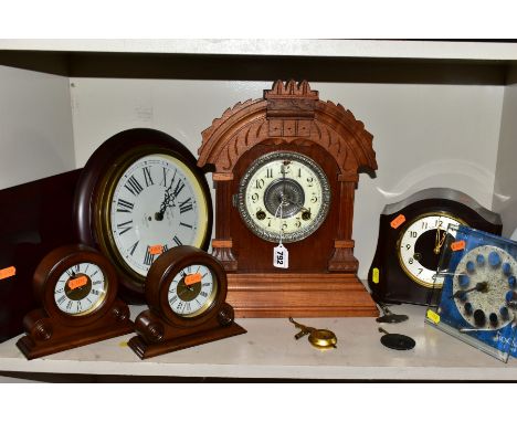 SEVEN VARIOUS MANTEL AND WALL CLOCKS, comprising a late 19th Century walnut cased Ansonia mantel clock, dial damaged, eight d