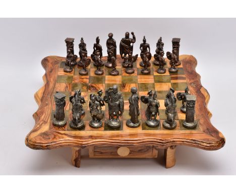 A SCRATCH BUILT WOODEN CHESS BOARD ON LEGS, two drawers to hold chess pieces, together with cast metal chess pieces modelled 