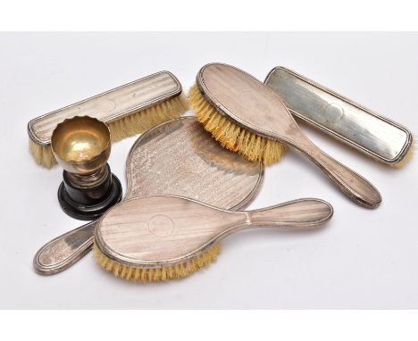 A FIVE PIECE SILVER VANITY SET AND A TROPHY CUP, the vanity set includes a handheld mirror, two hair brushes and two clothes 