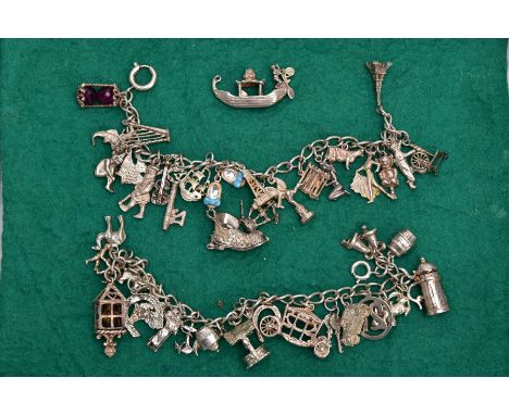 TWO WHITE METAL CHARM BRACELETS AND TWO LOOSE CHARMS, the first charm bracelet suspending twenty one charms in various forms 