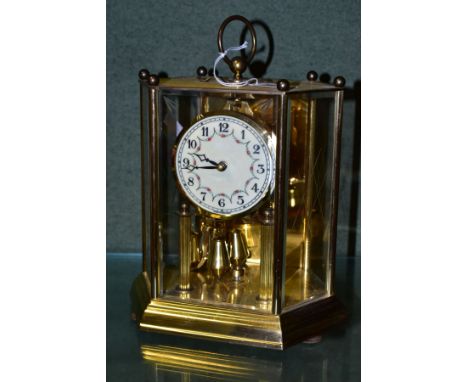 A MID 20TH CENTURY GERMAN KOMA BRASS CASED ANNIVERSARY CLOCK, of shaped hexagonal form, Arabic numerals on a floral painted e
