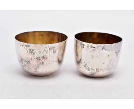 TWO 18TH CENTURY TUMBLECUPS, to include a plain polished design, engraved monogram, gilt interior, hallmarked Chester, makers