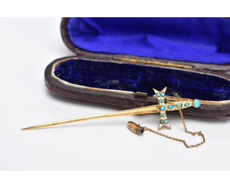 A YELLOW METAL SWORD STICK PIN, in the form of a sword set with a turquoise cabochon and white enamel detailed handle, fitted