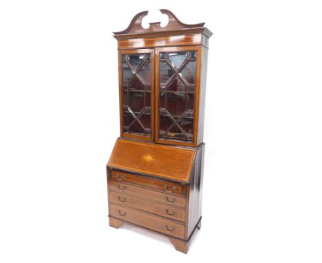 An Edwardian mahogany satinwood cross banded bureau bookcase, the topless swan neck pediment above two astragal glazed doors,