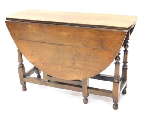 A 19thC oak D-end drop leaf gate leg table, on turned legs, some parts perhaps 18thC, when closed 76cm high, 110cm wide, 43cm