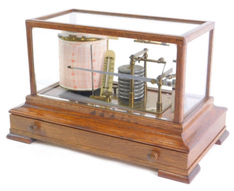 An oak cased and brass barograph, with fitted ivorine thermometer, in an oak case with drawer, 37cm wide.