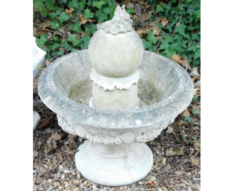 A composition stone fountain, of urn form decorated with fruit, leaves, etc., with central finial, 60cm diameter.