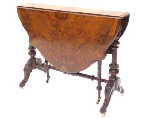 A Victorian walnut Sutherland table, with shaped drop leaf top, on turned supports terminating in cabriole legs with ceramic 