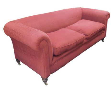 A Victorian walnut Chesterfield, set in deep red  pattern fabric on turned legs with ceramic castors, 202cm wide.