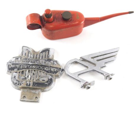 An Austin chrome plated car mascot, 7cm high, a Triumph for Sports Owners Association badge, and a miniature oil can in red. 