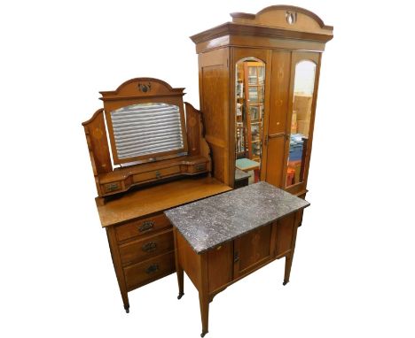 An early 20thC oak Art Nouveau style bedroom suite, in the manor of Liberty, each piece inlaid in boxwood and exotic timbers 