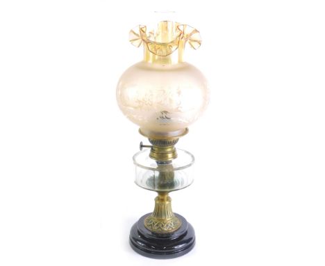 A Victorian oil lamp, the later opaque frosted shade decorated with scrolls and flowers, above a clear faceted glass reservoi