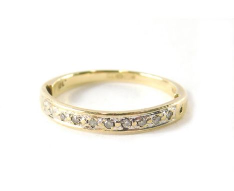 A 9ct gold diamond half hoop dress ring, set with twelve round brilliant cut diamonds, each in illusion setting, with single 