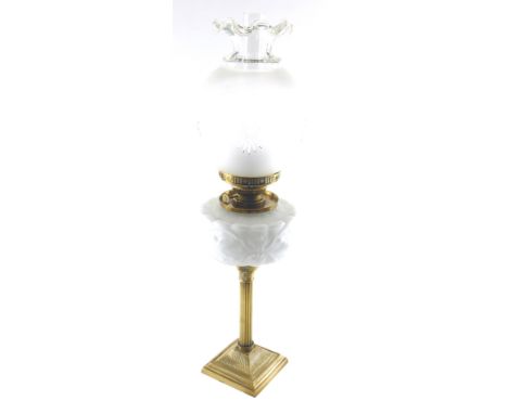 A late 19th/early 20thC oil lamp, the opaque shade with cut decoration of stars, above a white opaque reservoir moulded with 