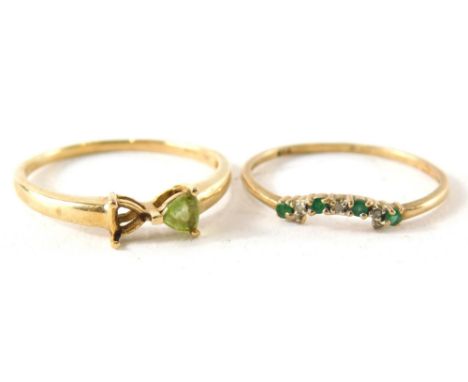 Two dress rings, comprising a 9ct gold two stone dress ring, set with peridot, one stone missing, ring size U, and a further 