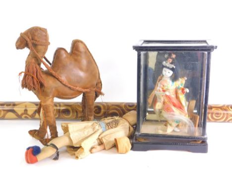Miscellaneous items, to include a Greek costume doll, a leather camel, an oriental costume doll in glazed case and a didgerid