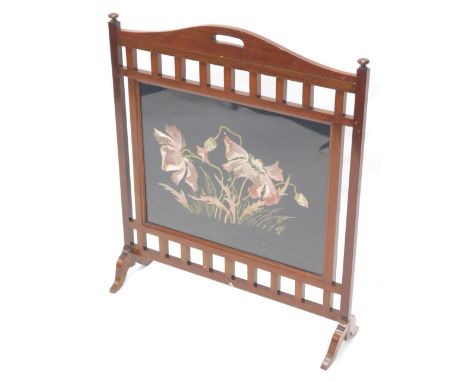 An early 19thC mahogany firescreen, the rectangular panel inserted with a crewelwork of poppies, on splayed feet, 73cm high, 