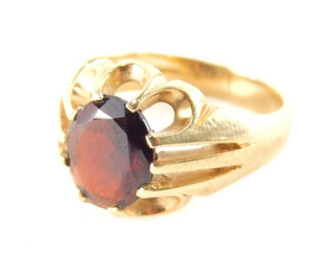 A 9ct gold gentleman's signet ring, set with single opal cut garnet, in claw setting, with pierced six point outer point bord