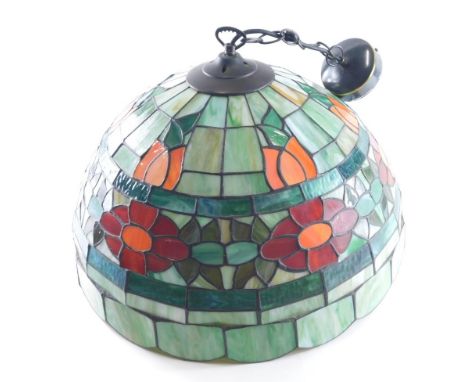 A Tiffany style lamp shade, decorated with flower heads, predominantly in green and orange, modern metal fitting, 29cm high.