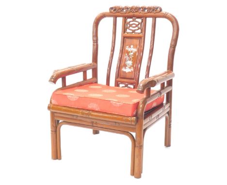 A Chinese hardwood open armchair, the back inlaid in mother of pearl with flowers, etc., carved with grapes and vines, with s