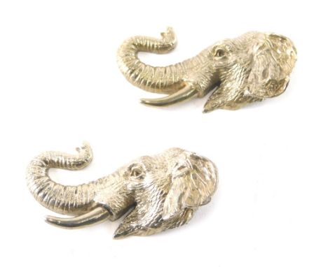 An elephant head brooch or charm, with trunk raised, marked sterling silver, 7cm wide, another similar, 2.2oz. (2) 