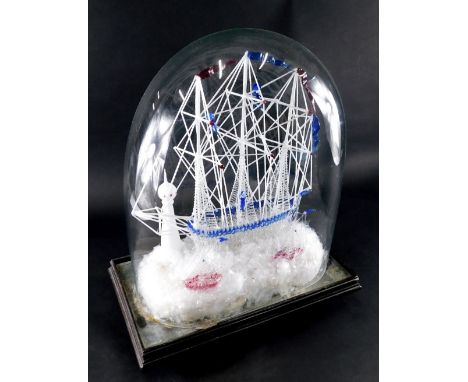 A Victorian glass model of a ship, with figures climbing rigging, shaped decking, etched in blue, with two small further ship