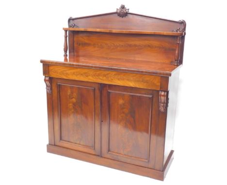 A Victorian figured mahogany chiffonier, the raised back with arched top carved with leaves, above a shaped shelf, on turned 