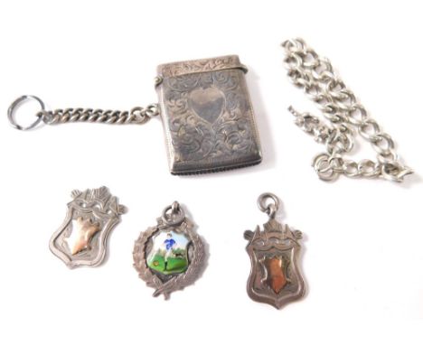 Various silver comprising three silver shield fobs, a silver curb link charm bracelet with Lincoln imp charm, 18cm long, and 