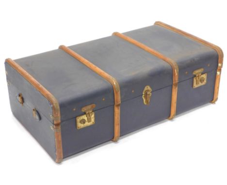 A black canvas and wooden banded trunk, with leather carrying handles, 91cm wide.
