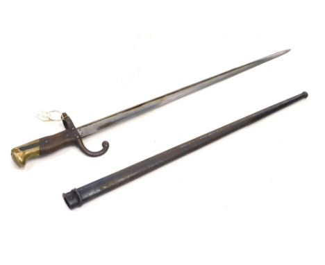 A St Etienne bayonet and scabbard, with shaped blade marked MO, with wooden handle, brass pommel, 66cm long.