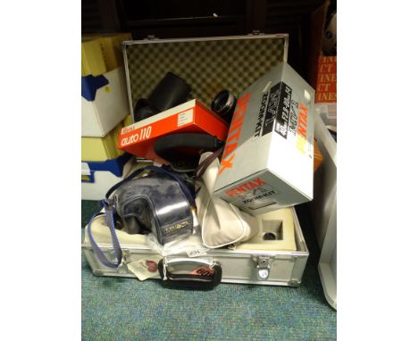 Miscellaneous camera equipment, to include a Minette reel container, Minolta 7000 camera with lenses, various lens coverings,