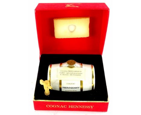 A bottle of Hennessy Napoleon Cognac, in barrel shaped decanter, boxed.
