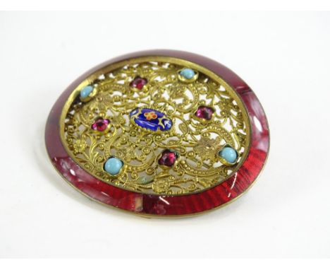 An Eastern buckle brooch, the original oval buckle with red enamel surround (AF), with later floral insert set with turquoise
