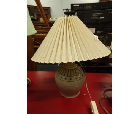 A Studio Pottery table lamp, decorated with geometric devices, on a cream ground, and a pleated shade.