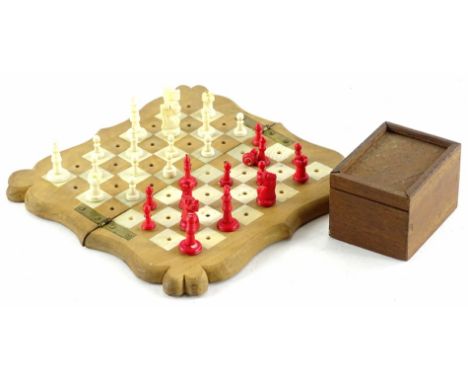 A late 19thC ivory travelling chess set, with fruitwood board, mahogany case with sliding lid, the board 16cm wide.