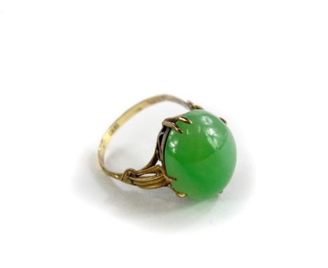 A jade set dress ring, with oval cabochon type cut pale green jade stone, 15mm x 12.2mm x 5.8mm, on a fine yellow metal wirew