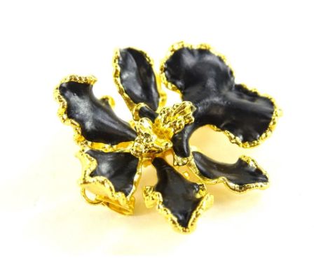 A modern costume jewellery brooch in the design of a flower, with black enamel type design, stamped DKK3, 4cm wide.