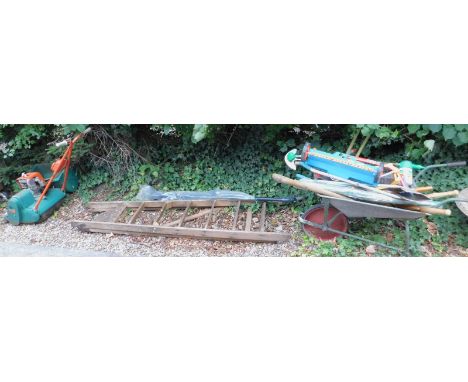 A quantity of garden tools, step ladder and a Suffolk Punch lawn mower.
