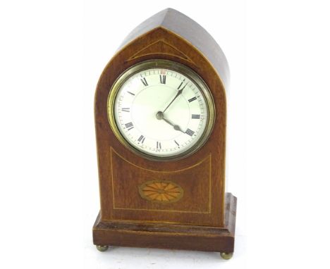 An Edwardian mahogany and inlaid mantel clock, of lancet shape, with French painted dial and brass movement, on brass bun fee