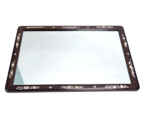 A rectangular mother of pearl finish polished hardwood mirror, set with a repeat decoration of entwined flowers, broken by fu