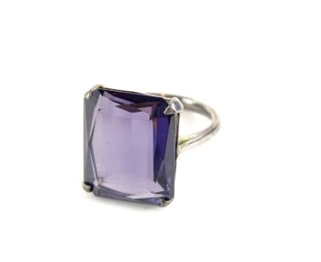 A chunky design dress ring, set with rectangular cut purple coloured paste stone, in a white metal setting, unmarked, ring si