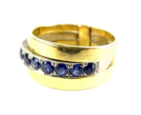 A three ring design single dress ring, with central platinum band, set with sapphires, with two outer coloured yellow metal b