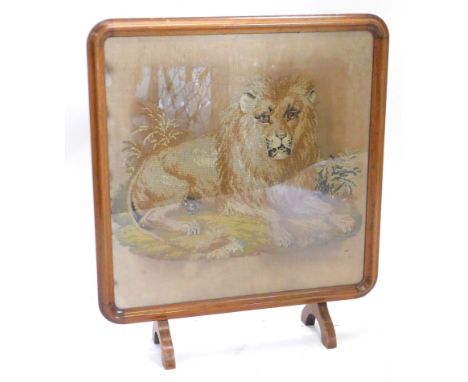 A Victorian woolwork banner, embroidered with a seated lion, coloured wools, later mounted in contemporary rosewood frame, wi